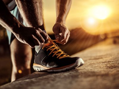 Man tying jogging shoes