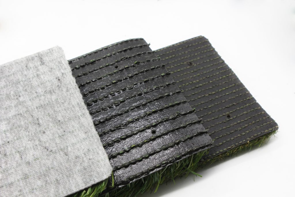 Backing is one of the key components when producing artificial grass. It is the layer that ensures that the fibres stay where they have been tufted and prevents them from pulling out. The backing also provides the playing surface with extra weight, which adds to the overall stability of the carpet.